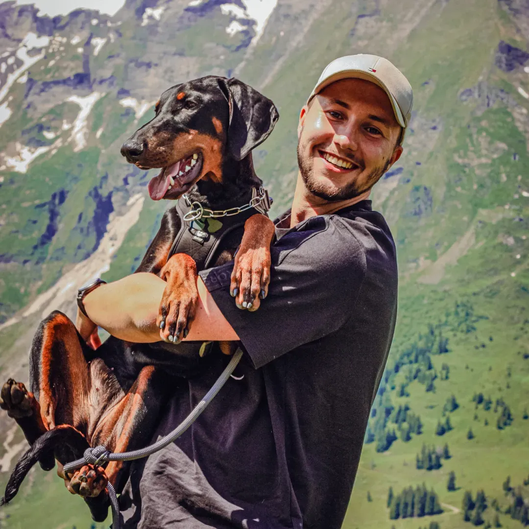 Bohuslav holding a dog in the mountains